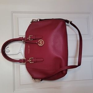 Dark red Michael Kors satchel purse with shoulder strap